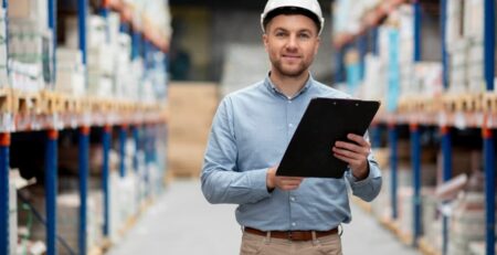 a man in a hard hat holding a clipboard