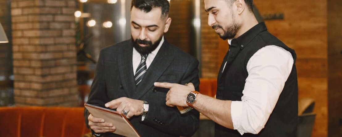 a man pointing at a tablet