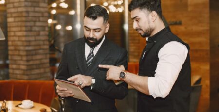 a man pointing at a tablet