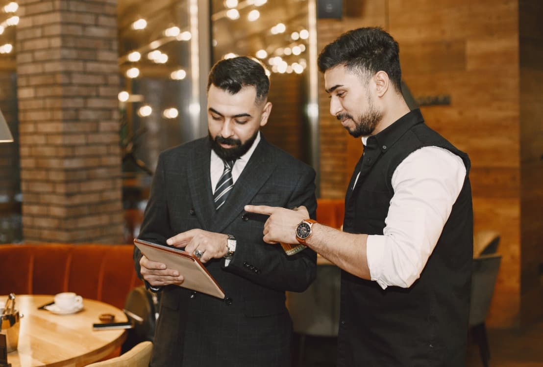 a man pointing at a tablet